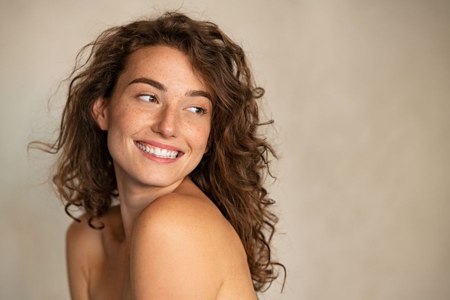 woman smiling looking away from camera